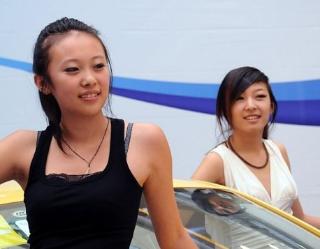 Two Chines Girls and a new Volkswagen Polo