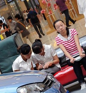 Two Chines Girls and a new Volkswagen Polo