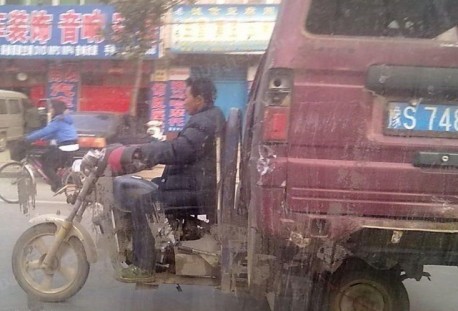 Transporting a minivan on a tricycle in China