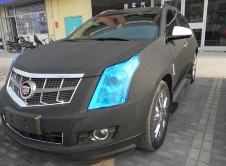 Cadillac SRX in matte-black with blue lights in China