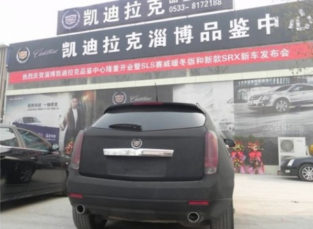 Cadillac SRX in matte-black with blue lights in China
