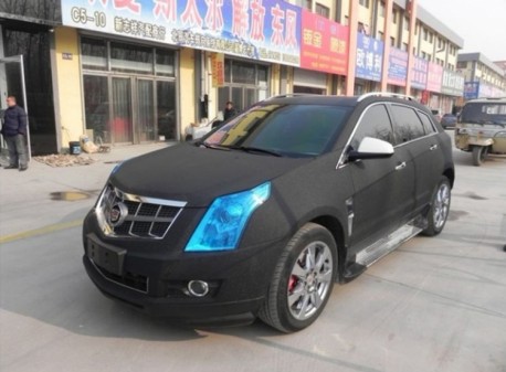 Cadillac SRX in matte-black with blue lights in China