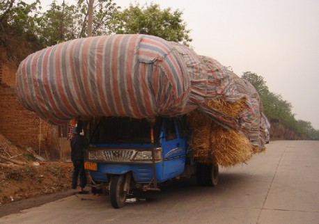 A slightly overloaded motorized tricycle in China