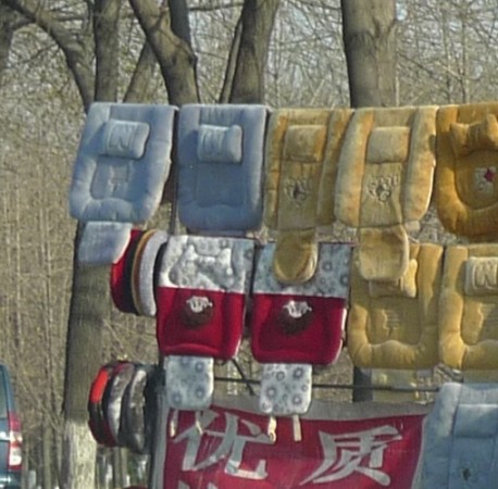 Selling seat covers & rocking horses along the Road in China