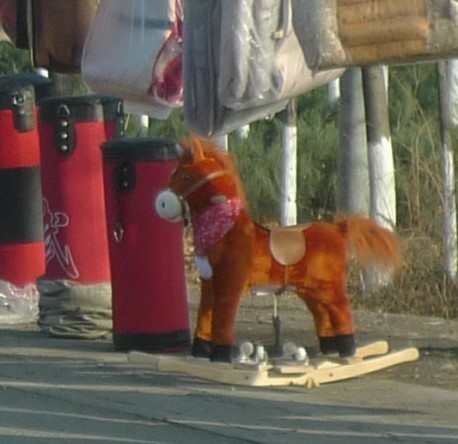 Selling seat covers & rocking horses along the Road in China