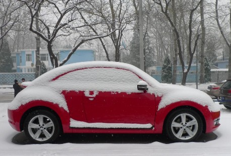 A red Volkswagen Beetle in the Snow in Beijing