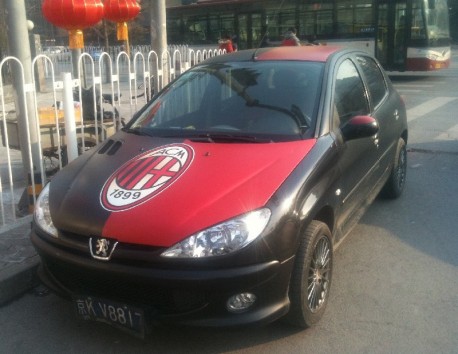 Chinese man is a Milan fan in a Peugeot 207