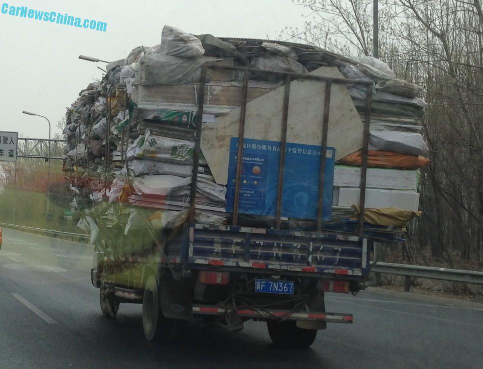 Video of overloaded truck teetering past pedestrians with inches to spare  in China