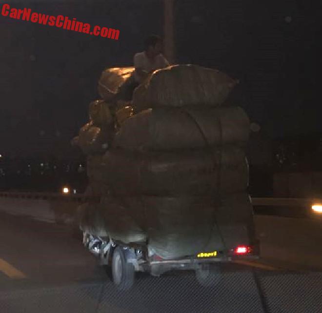 Overloaded Tricycle Is Topped With A Woman On A Highway In China
